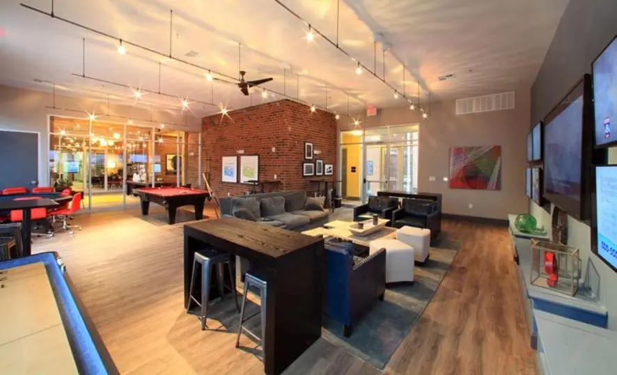 Game room with pool table, plasma TV, and gaming stations at University Edge - University of Akron off-campus housing